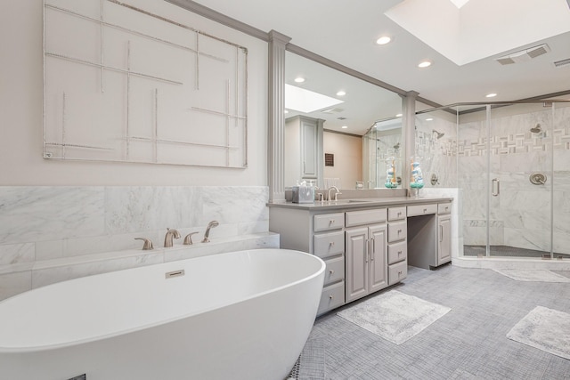 6141 Prestondell Ct, Dallas, TX 75240 - full bathroom with vanity, a freestanding bath, recessed lighting, a shower stall, and a skylight