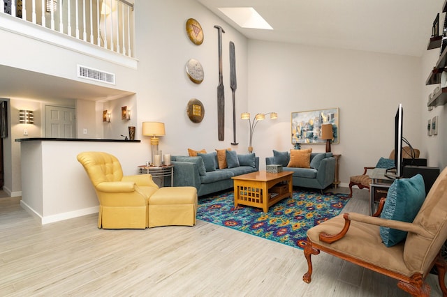6141 Prestondell Ct, Dallas, TX 75240 - living area featuring a skylight, high vaulted ceiling, and wood finished floors