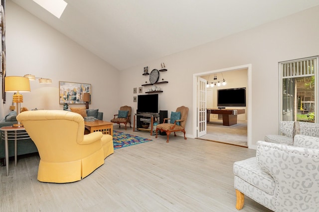6141 Prestondell Ct, Dallas, TX 75240 - living area with wood finished floors, a chandelier, a skylight, and high vaulted ceiling