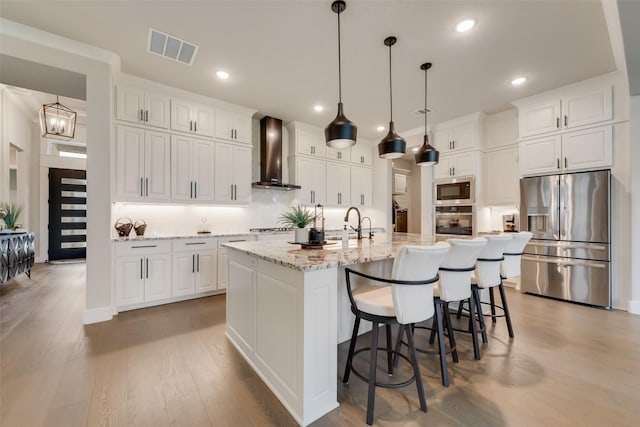 12480 Palmer Dr, Fort Worth, TX 76179 - kitchen with appliances with stainless steel finishes, wall chimney exhaust hood, tasteful backsplash, white cabinets, and recessed lighting