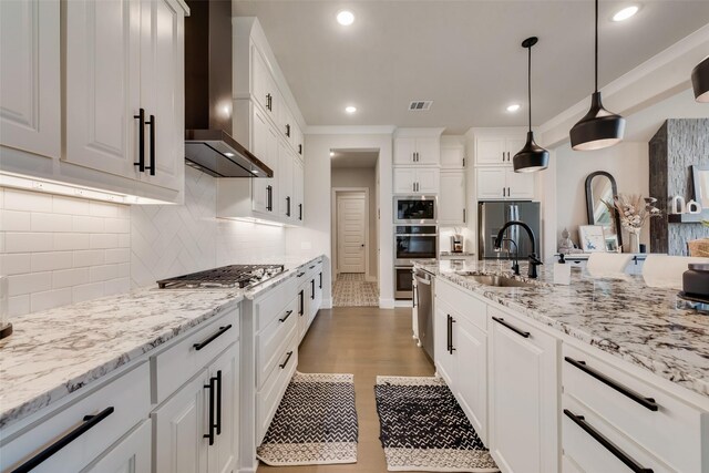 12480 Palmer Dr, Fort Worth, TX 76179 - kitchen featuring wall chimney exhaust hood, appliances with stainless steel finishes, white cabinetry, light stone countertops, and recessed lighting