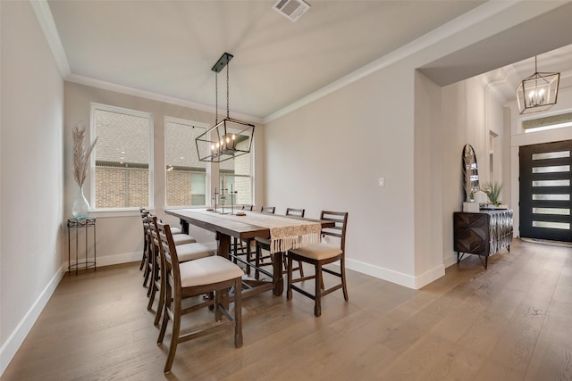 12480 Palmer Dr, Fort Worth, TX 76179 - dining area featuring a chandelier, plenty of natural light, wood finished floors, and crown molding