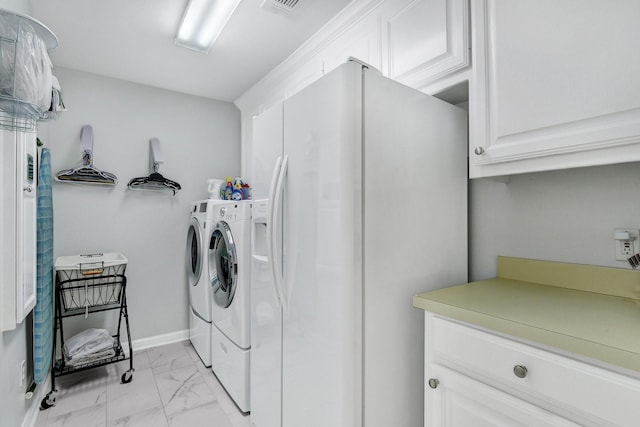 2310 Auburn Ct, Sherman, TX 75092 - laundry area featuring cabinet space, washing machine and clothes dryer, and light marble finish flooring