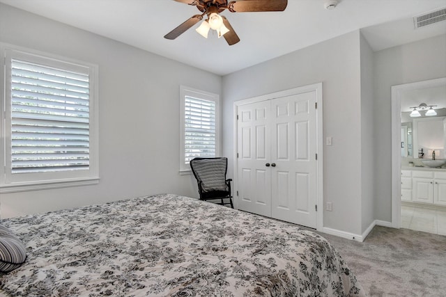 2310 Auburn Ct, Sherman, TX 75092 - bedroom with light colored carpet, a closet, ceiling fan, and ensuite bath