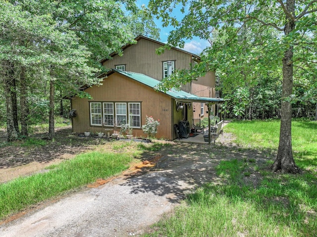 1605 County Road 1195, Yantis, TX 75497 - view of front facade featuring driveway and a metal roof