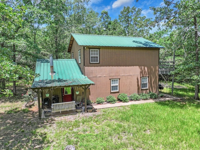 1605 County Road 1195, Yantis, TX 75497 - rustic home featuring a metal roof, a porch, and a front lawn