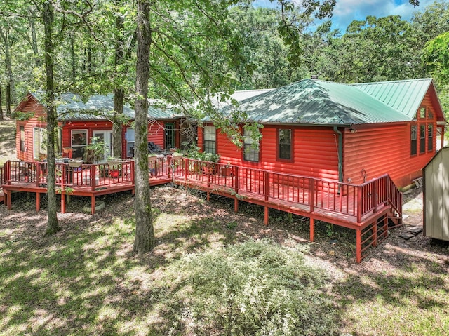 1605 County Road 1195, Yantis, TX 75497 - back of house featuring a wooden deck, a metal roof, and log veneer siding
