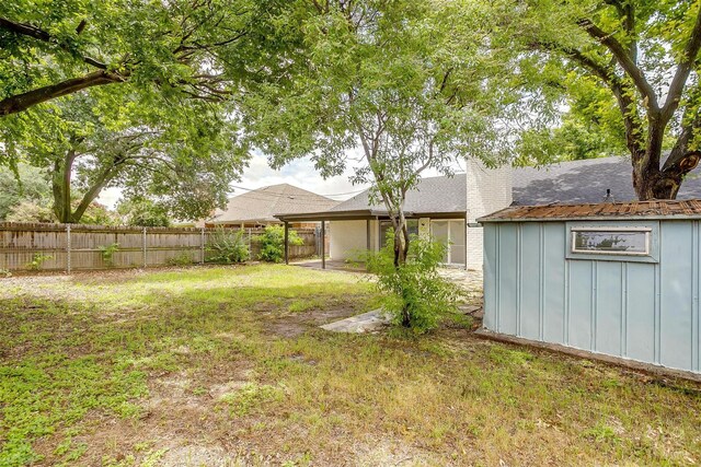 3925 Singleleaf Ln, Fort Worth, TX 76133 - fenced backyard featuring a storage shed