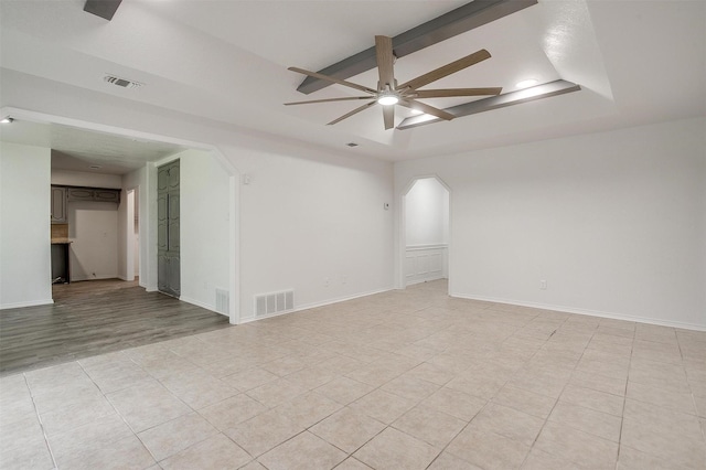 3925 Singleleaf Ln, Fort Worth, TX 76133 - empty room featuring a ceiling fan, a tray ceiling, arched walkways, light tile patterned floors, and recessed lighting