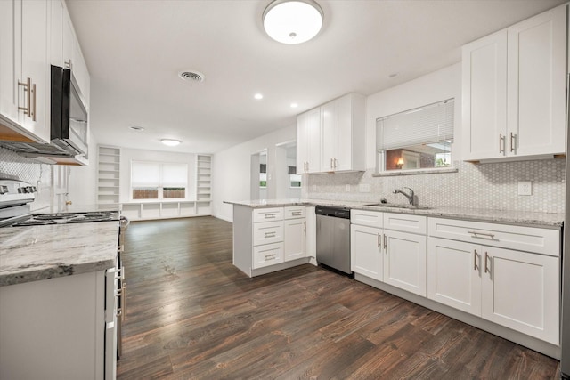 2250 Capri Dr, Fort Worth, TX 76114 - kitchen featuring appliances with stainless steel finishes, dark wood-type flooring, white cabinets, backsplash, and recessed lighting