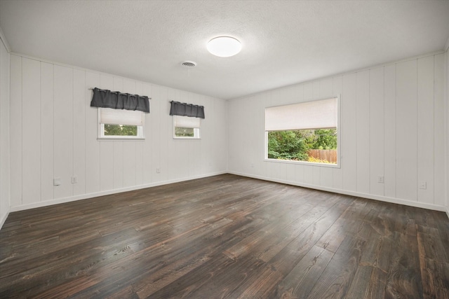 2250 Capri Dr, Fort Worth, TX 76114 - unfurnished room with dark wood finished floors and a textured ceiling