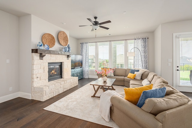 1251 Castle Dr, Prosper, TX 75078 - living room with dark wood-type flooring, plenty of natural light, a stone fireplace, and ceiling fan