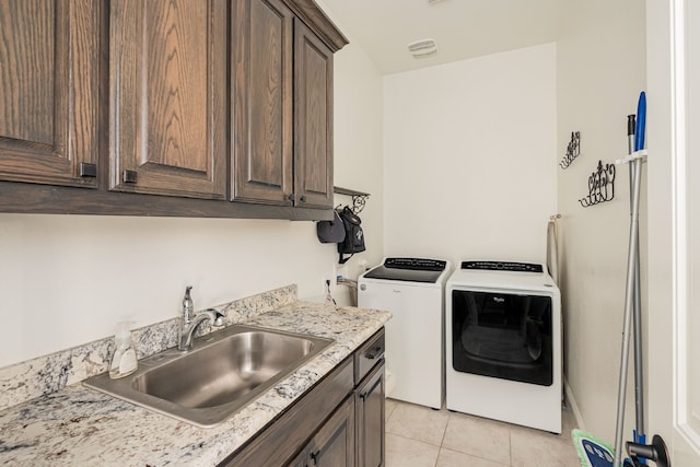 1251 Castle Dr, Prosper, TX 75078 - laundry room featuring washer and clothes dryer, cabinet space, and light tile patterned flooring