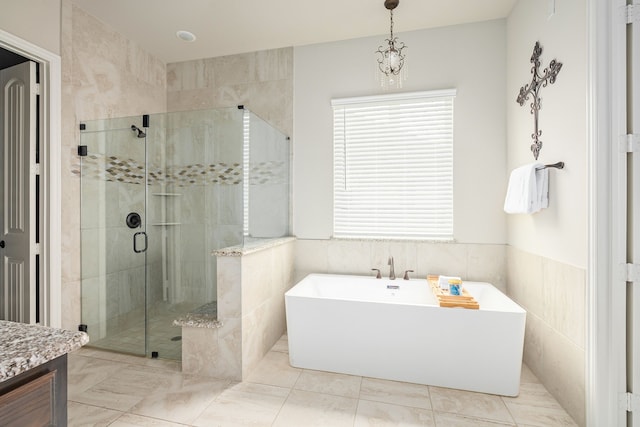 1251 Castle Dr, Prosper, TX 75078 - full bath with a soaking tub, a shower stall, tile walls, vanity, and a wainscoted wall