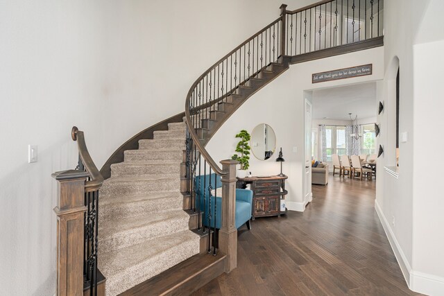 1251 Castle Dr, Prosper, TX 75078 - staircase featuring wood finished floors and a high ceiling