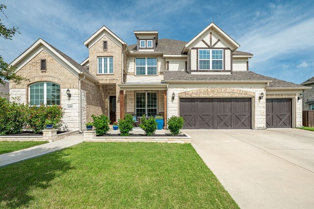 1251 Castle Dr, Prosper, TX 75078 - view of front of property with a front yard, driveway, roof with shingles, and brick siding