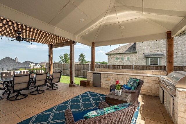 1251 Castle Dr, Prosper, TX 75078 - fenced backyard with an outdoor kitchen, outdoor dining area, a patio area, an outdoor hangout area, and a pergola