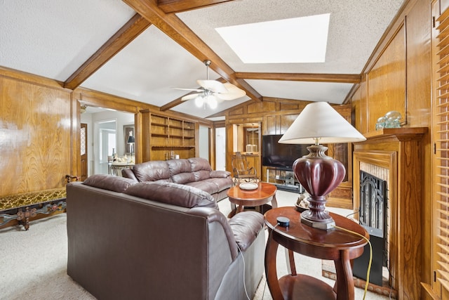 1301 Warwick St, Garland, TX 75040 - living area with a skylight, carpet, wooden walls, a fireplace, and ceiling fan