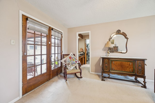 1301 Warwick St, Garland, TX 75040 - sitting room featuring french doors, carpet flooring, and a textured ceiling