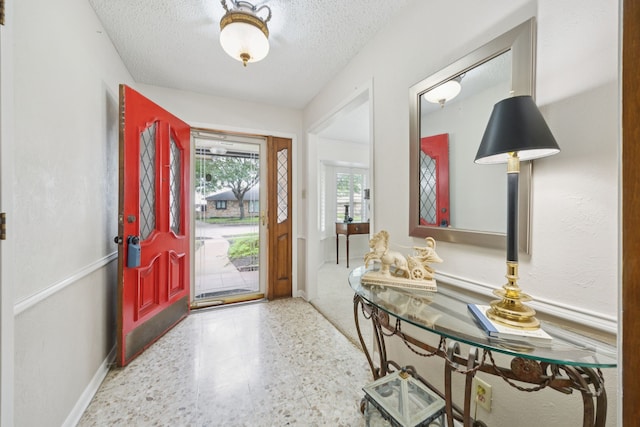 1301 Warwick St, Garland, TX 75040 - foyer entrance featuring speckle patterned floor and a textured ceiling