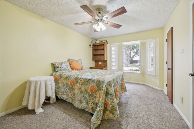 1301 Warwick St, Garland, TX 75040 - bedroom featuring carpet flooring, a textured ceiling, and ceiling fan