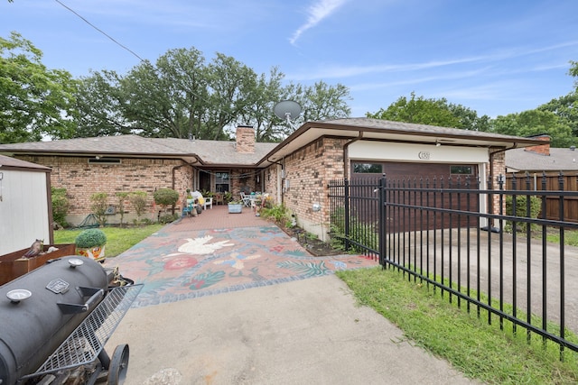 1301 Warwick St, Garland, TX 75040 - single story home with a fenced front yard, brick siding, a chimney, and a shingled roof