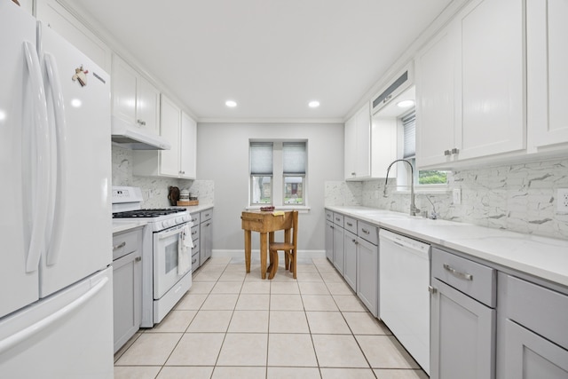 1301 Warwick St, Garland, TX 75040 - kitchen featuring white appliances, under cabinet range hood, backsplash, gray cabinetry, and light tile patterned flooring