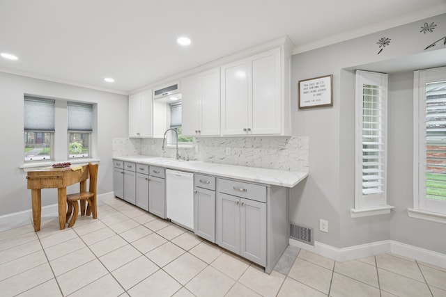 1301 Warwick St, Garland, TX 75040 - kitchen with dishwasher, gray cabinets, decorative backsplash, light tile patterned floors, and recessed lighting