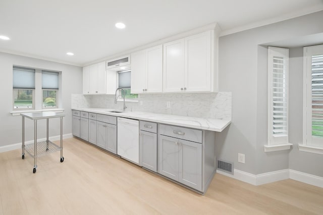 1301 Warwick St, Garland, TX 75040 - kitchen featuring dishwasher, tasteful backsplash, gray cabinetry, light wood-style floors, and recessed lighting