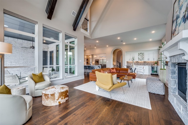 3791 Marble Hill Rd, Frisco, TX 75034 - living room featuring a fireplace, wood finished floors, high vaulted ceiling, arched walkways, and beamed ceiling