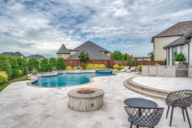 3791 Marble Hill Rd, Frisco, TX 75034 - view of swimming pool featuring an outdoor kitchen, an outdoor fire pit, a fenced backyard, and a patio area
