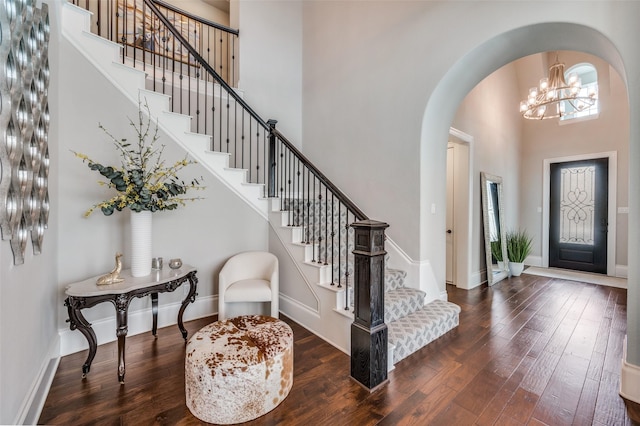 3791 Marble Hill Rd, Frisco, TX 75034 - entryway featuring a high ceiling, arched walkways, wood-type flooring, stairway, and a chandelier