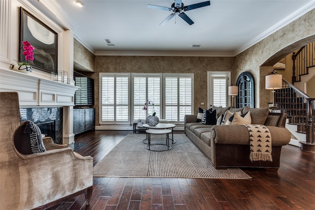 1641 Crockett Dr, Frisco, TX 75033 - living area featuring stairs, a ceiling fan, arched walkways, wood-type flooring, and a fireplace