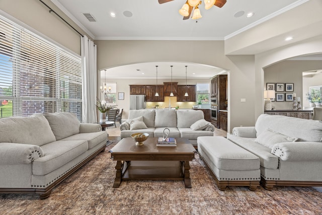 881 Derick Ln, Prosper, TX 75078 - living area featuring arched walkways, a ceiling fan, crown molding, healthy amount of natural light, and recessed lighting