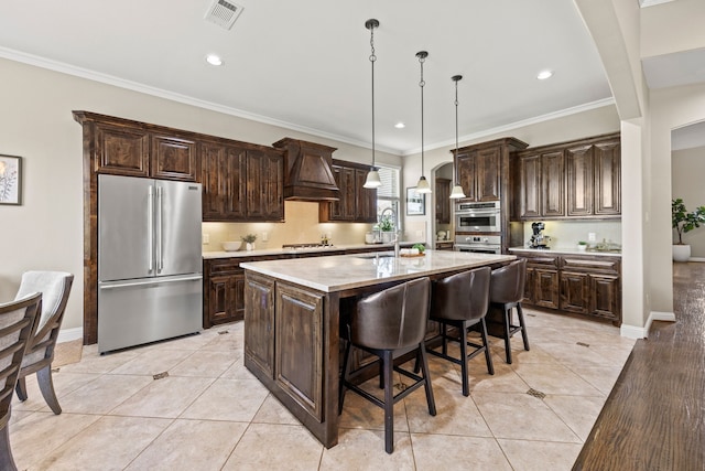 881 Derick Ln, Prosper, TX 75078 - kitchen with appliances with stainless steel finishes, custom range hood, dark brown cabinets, light countertops, and crown molding
