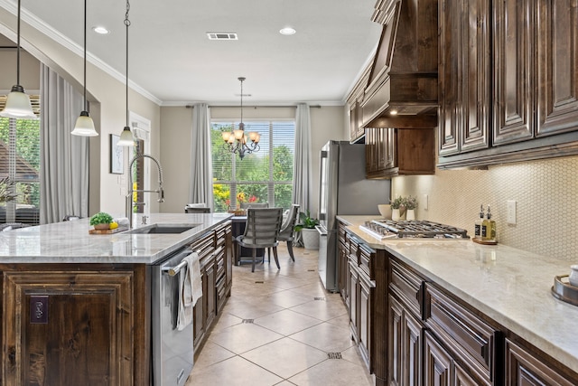 881 Derick Ln, Prosper, TX 75078 - kitchen with wall chimney range hood, appliances with stainless steel finishes, decorative backsplash, ornamental molding, and a chandelier