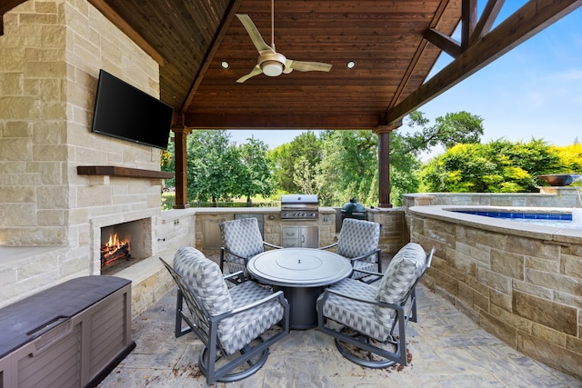881 Derick Ln, Prosper, TX 75078 - view of patio with an outdoor stone fireplace, exterior kitchen, and a ceiling fan