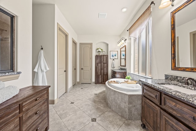 881 Derick Ln, Prosper, TX 75078 - bathroom with two vanities, a garden tub, and tile patterned floors