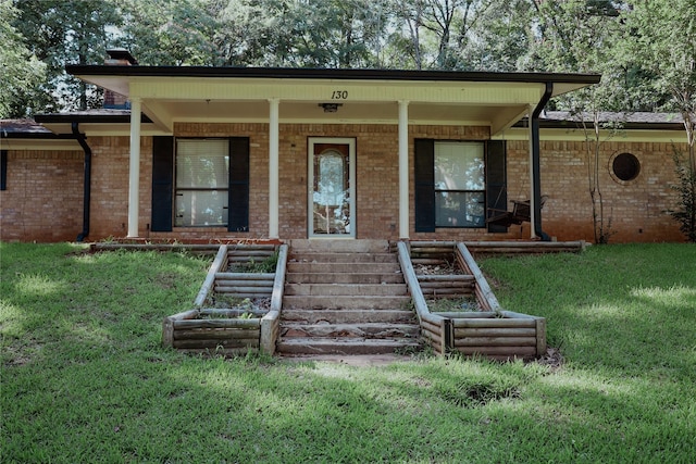 130 Golfcrest St, Rusk, TX 75785 - view of front of house featuring brick siding, a front lawn, and covered porch