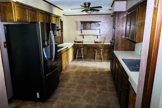 130 Golfcrest St, Rusk, TX 75785 - kitchen with refrigerator with ice dispenser, ceiling fan, light countertops, ornamental molding, and stone finish floors