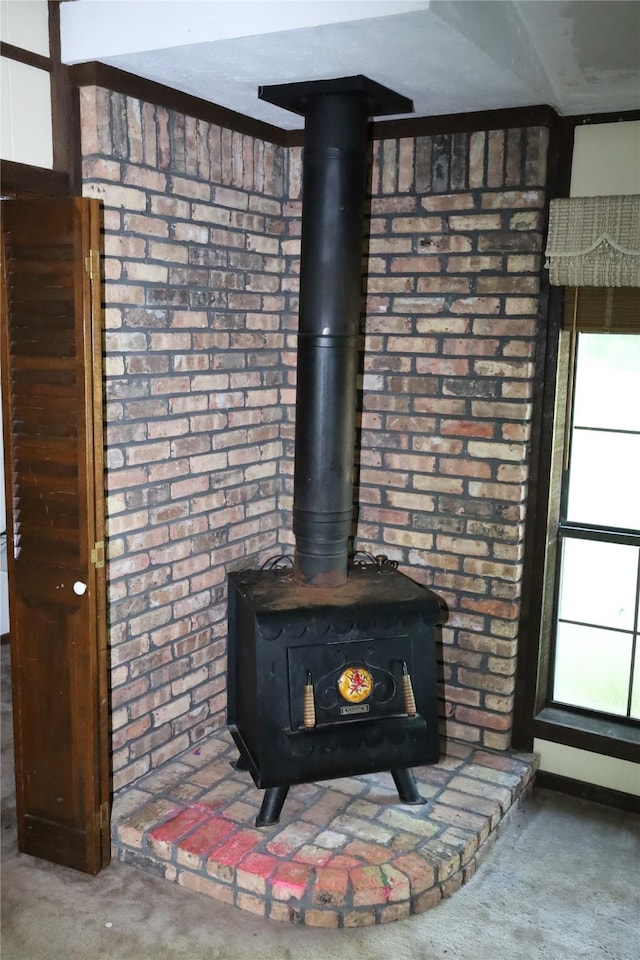 130 Golfcrest St, Rusk, TX 75785 - detailed view of a wood stove, carpet floors, and brick wall