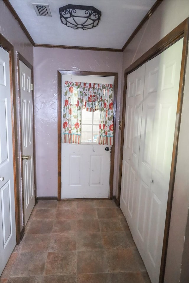 130 Golfcrest St, Rusk, TX 75785 - doorway to outside with ornamental molding and stone finish floors