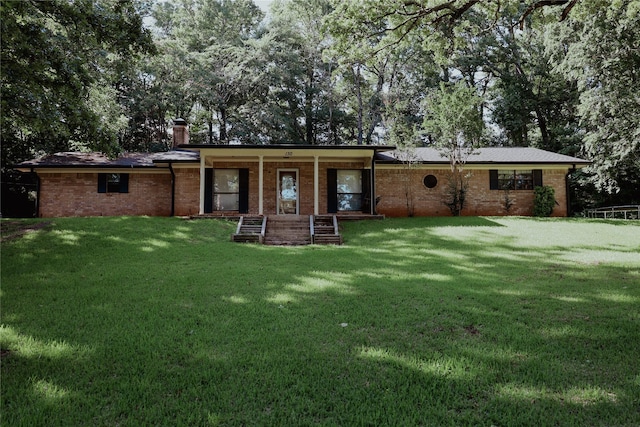 130 Golfcrest St, Rusk, TX 75785 - view of front of home with a front lawn, brick siding, and a chimney