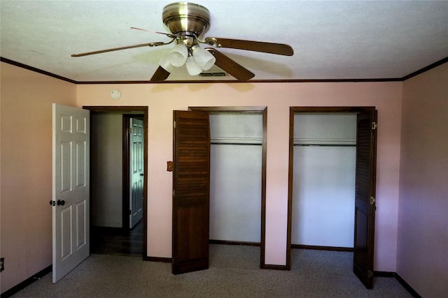 130 Golfcrest St, Rusk, TX 75785 - unfurnished bedroom with multiple closets, carpet floors, ornamental molding, and a ceiling fan