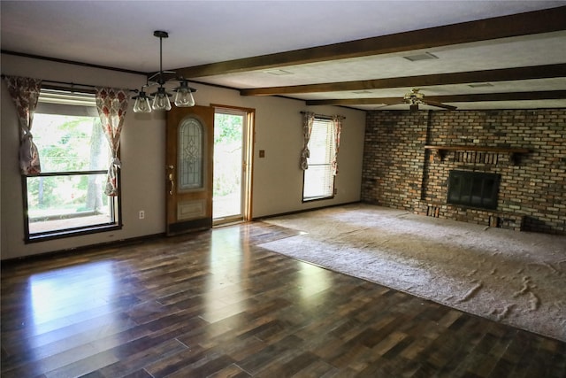 130 Golfcrest St, Rusk, TX 75785 - unfurnished living room with a brick fireplace, ceiling fan, wood finished floors, healthy amount of natural light, and beamed ceiling