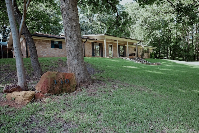 130 Golfcrest St, Rusk, TX 75785 - view of front of house featuring brick siding and a front yard