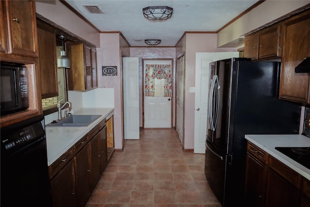 130 Golfcrest St, Rusk, TX 75785 - kitchen featuring crown molding, black appliances, light countertops, decorative light fixtures, and dark brown cabinetry