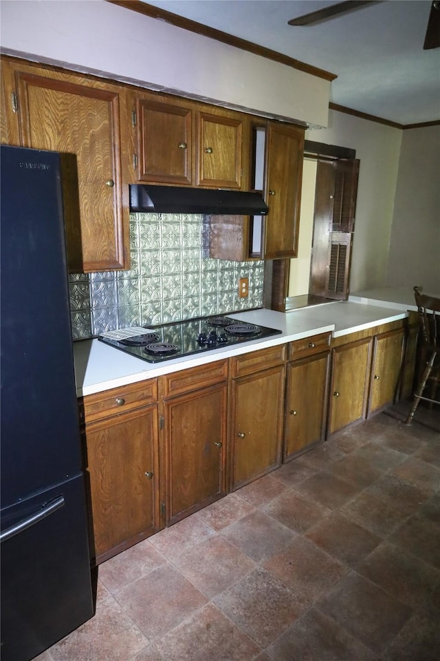 130 Golfcrest St, Rusk, TX 75785 - kitchen featuring black appliances, tasteful backsplash, ornamental molding, under cabinet range hood, and light countertops