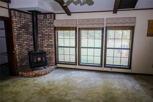 130 Golfcrest St, Rusk, TX 75785 - unfurnished living room with beamed ceiling, carpet, a wood stove, and ceiling fan