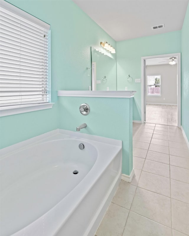 5365 Saba Dr, Fort Worth, TX 76119 - full bathroom with tile patterned flooring, a garden tub, and ceiling fan